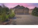 Two-story house with stone and siding, two-car garage, and landscaping at 4993 Sedona Cir, Parker, CO 80134