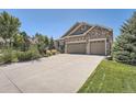 Two-story house with stone and siding, two-car garage, and landscaping at 4993 Sedona Cir, Parker, CO 80134