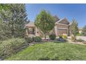 Landscaped front yard with manicured lawn and stone accents at 4993 Sedona Cir, Parker, CO 80134