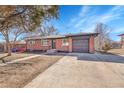 Charming brick home featuring a convenient attached garage and a well-manicured front yard at 3272 W Stanford W Ave, Englewood, CO 80110
