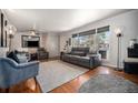 Bright living room with hardwood floors, a large window, and comfortable seating at 7071 Beach St, Westminster, CO 80030