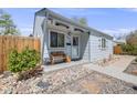Charming home featuring a cozy front porch, decorative bench, and well-maintained landscaping at 935 Newark St, Aurora, CO 80010