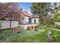 Charming home exterior with beautiful landscaping, a red tile roof, and an inviting front patio at 229 Albion St, Denver, CO 80220