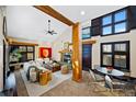Open concept living room has a fireplace, high ceilings, and an adjacent dining area at 229 Albion St, Denver, CO 80220