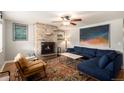 Cozy living room featuring a brick fireplace, a comfortable sofa, and stylish decor, perfect for relaxation at 6676 S Kit Carson St, Centennial, CO 80121