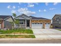Beautifully landscaped single-story home with a cozy front porch and two-car garage at 1144 Ridgefield Dr, Berthoud, CO 80513