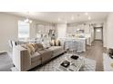 Open-concept living area with a modern kitchen, dining space, and stylish decor at 1144 Ridgefield Dr, Berthoud, CO 80513