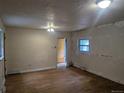 Spacious living room with hardwood floors, natural light, and a view into adjoining rooms at 4209 Perry St, Denver, CO 80212