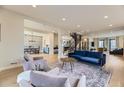 Bright, open-concept living space with hardwood floors, stylish furnishings, and an eye-catching staircase at 2635 S Monroe St, Denver, CO 80210