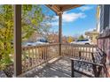 Covered porch with wood bench, overlooking the neighborhood at 14449 E 101St Pl, Commerce City, CO 80022