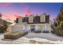 Inviting two-story home with a manicured front yard and a driveway, all dusted with a layer of fresh snow at 6330 E Irwin Pl, Centennial, CO 80112