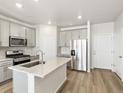 Modern kitchen featuring stainless steel appliances, gray cabinets, and a spacious center island at 22360 E 8Th Ave, Aurora, CO 80018