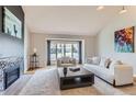 Bright living room with vaulted ceiling, a fireplace, and large windows at 5275 Holmes Pl, Boulder, CO 80303
