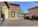 A covered patio with stone columns, an iron railing, and outdoor furniture at 4822 Bandera Pl, Parker, CO 80134