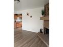 Open-concept living area with a brick fireplace and view into the kitchen at 5640 E 67Th Pl, Commerce City, CO 80022