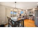Bright kitchen with stainless steel appliances, granite countertops, and a dining area with backyard access at 8975 S Coyote St, Highlands Ranch, CO 80126