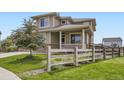 Charming home featuring a classic wooden fence, lush green lawn, and inviting front porch at 785 Iris St, Brighton, CO 80601
