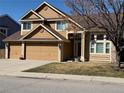 Charming two-story home with a three-car garage, well-maintained lawn, and inviting entrance at 1045 English Sparrow Trl, Highlands Ranch, CO 80129