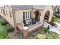 Inviting front porch with brick railing and comfortable chairs for enjoying the outdoors at 1582 Fairfax St, Denver, CO 80220