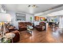Inviting open-concept living room flowing into the kitchen and dining area, featuring hardwood floors and comfortable seating at 4528 Andes St, Denver, CO 80249