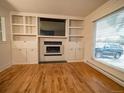 Living room features a fireplace with built-in shelving and bright windows at 17973 E Iowa Dr, Aurora, CO 80017