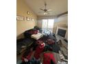 Bright living room featuring a fireplace, sliding glass doors, and ceiling fan at 5255 Memphis St # 121, Denver, CO 80239
