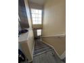Carpeted staircase with a large window providing natural light at 5255 Memphis St # 121, Denver, CO 80239