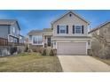 Charming two-story home with a well-maintained lawn and attached two-car garage at 16149 Peregrine Dr, Parker, CO 80134