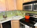 Well-lit kitchen with stainless steel appliances and trendy green backsplash at 1833 N Williams St # 507, Denver, CO 80218