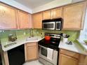 Efficient kitchen with stainless steel appliances and bright, light wood cabinets at 1833 N Williams St # 507, Denver, CO 80218