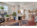 Spacious living area with hardwood floors flowing into an open concept dining and kitchen area at 410 Acoma St # 515, Denver, CO 80204