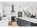 Bright kitchen with stainless steel appliances, an island with seating, and stylish pendant lighting at 6725 Beech Ct, Arvada, CO 80004
