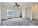 Bright living room with large window and a ceiling fan creating a cozy and inviting atmosphere at 19213 E Idaho Dr # 105, Aurora, CO 80017