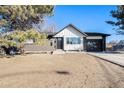 Charming remodeled single-story home with a new driveway and black two-car garage at 8348 Cherokee St, Denver, CO 80221