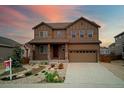 Charming two-story home featuring a landscaped front yard and inviting covered porch at 7465 Grady Cir, Castle Rock, CO 80108