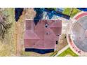 Aerial view of the house showing the roof, gutters, downspouts, and nearby sidewalks at 6882 Quail St, Arvada, CO 80004