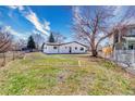 Large backyard with a chain link fence and frame for a shed or outdoor structure at 6882 Quail St, Arvada, CO 80004