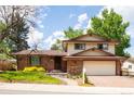 Two story brick home with an attached two car garage and paved driveway leading up to front entrance at 11131 W Oregon Pl, Lakewood, CO 80232