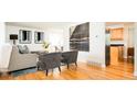 Open living room with hardwood floors, neutral color scheme, and modern furniture that add to the inviting space at 11131 W Oregon Pl, Lakewood, CO 80232