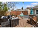 Backyard with a deck featuring a stock tank pool, lounge seating, and privacy fence at 11031 Marshall St, Westminster, CO 80020