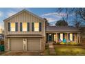 Charming two-story home featuring a two-car garage and a welcoming front porch at 15865 E Kepner Dr, Aurora, CO 80017