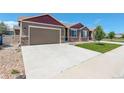 Lovely home with a spacious driveway, attached garage, and a well-maintained front yard and stone accents at 11129 Paradise Ln, Firestone, CO 80504