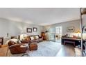Comfortable living area with sliding door access to a sunroom offering natural light at 13626 E Bates Ave # 302, Aurora, CO 80014