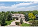 Beautiful home on a large lot with lush landscaping, circular driveway, and a three-car garage at 5301 S Birch Ct, Greenwood Village, CO 80121