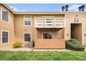 A charming condo exterior with a private patio area and balcony under a clear blue sky at 10251 W 44Th Ave # 7-106, Wheat Ridge, CO 80033