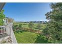 Expansive backyard with well-manicured lawn, wooden fence, and neighborhood views at 10125 Quarry Hill Pl, Parker, CO 80134