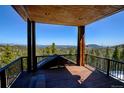 An exterior patio space features a covered area and expansive views at 10508 Christopher Dr, Conifer, CO 80433
