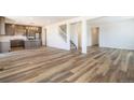 Bright open floorplan with kitchen, staircase and living space featuring light wood flooring at 2177 Garden Ave, Brighton, CO 80601