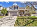 Beautiful two-story home with a well-maintained lawn and covered front porch at 19447 E Bellisario Creek Dr, Parker, CO 80134