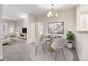 Charming dining room with modern lighting, stylish decor, and seamless access to the living area at 3995 S Dillon Way # 102, Aurora, CO 80014